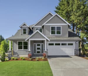 A gray house with a garage and a driveway.