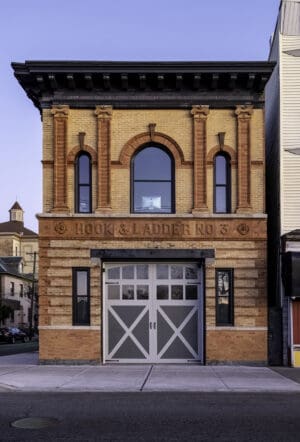 A brick building with a large garage door.