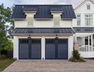 A two story home with two garage doors.